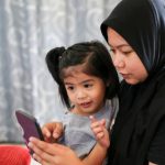 Muslim family spending leisure time at home.